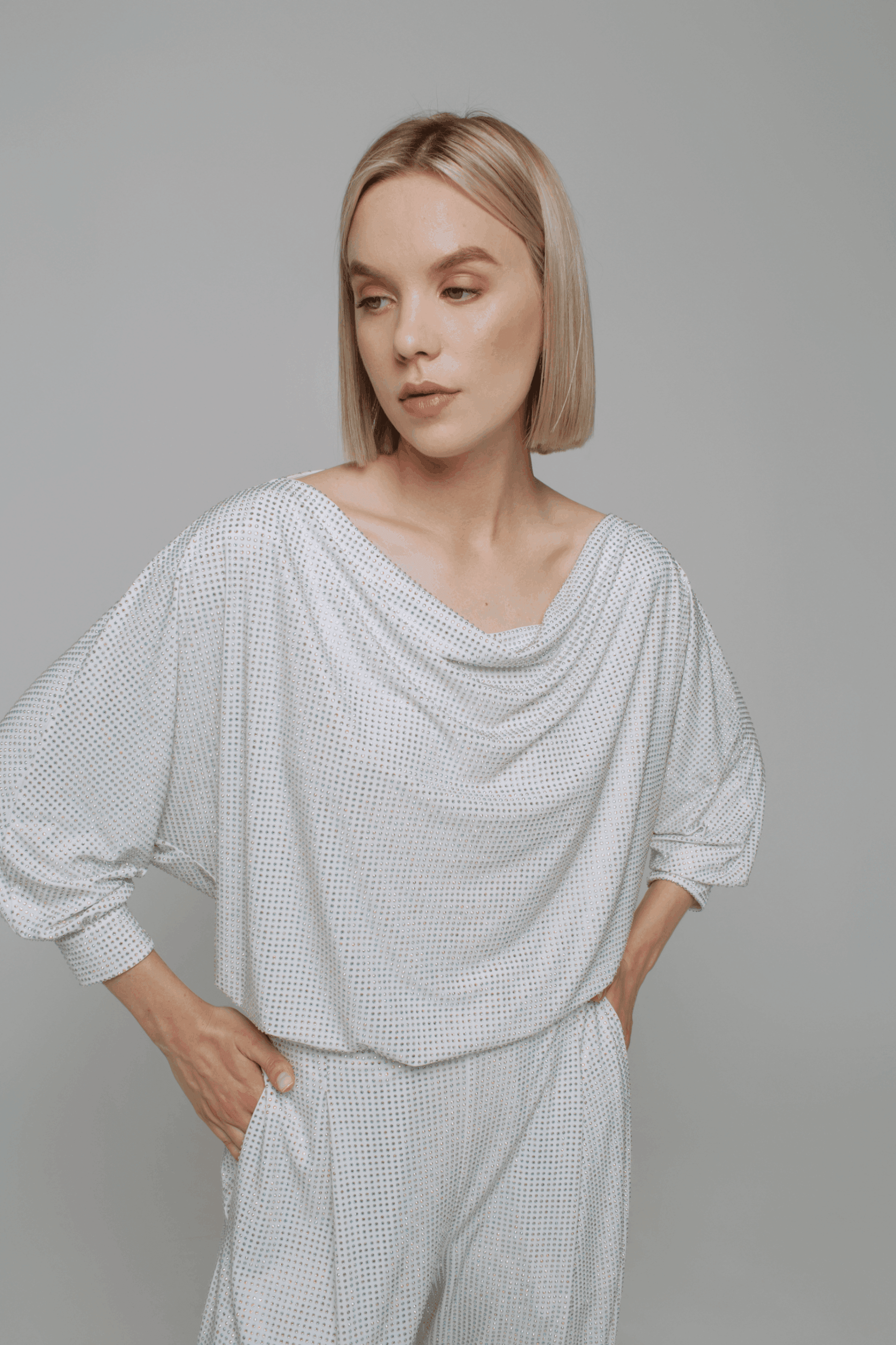 Exquisite detail of Crystal Cowlneck Three Quarter Dolman Sleeves showcasing the fine craftsmanship and elegant design characteristic of Axinia Collection 's luxury collection.