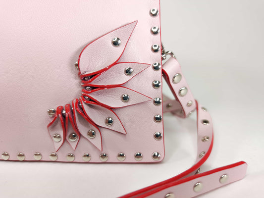 Exquisite detail of Clutch Bag With Wings and Rivets showcasing the fine craftsmanship and elegant design characteristic of Axinia Collection 's luxury collection.